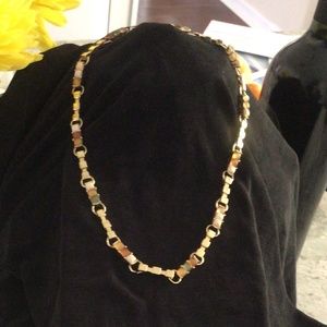 Necklace in goldtone, set with green pale, amber and cream 16.74”